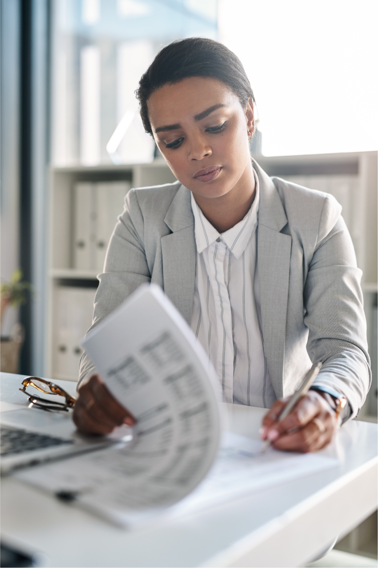 Woman reviewing paperwork at her desk